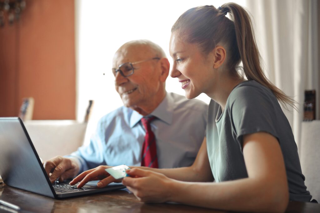 Zwei Personen schauen auf ein Laptop